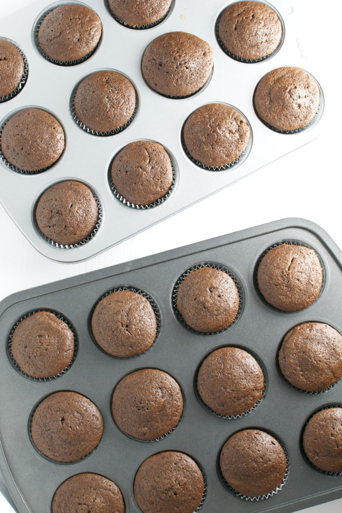 Delicious homemade chocolate muffins baking in muffin tins, fresh out of the oven, perfect for dessert or snack.
