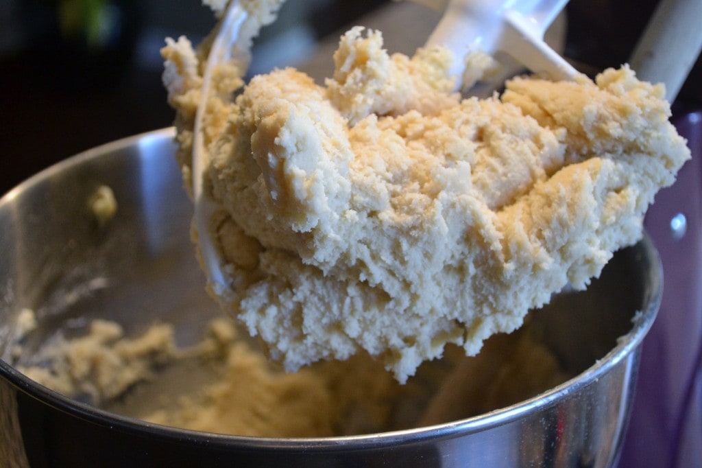 Creamy homemade cut out sugar cookie dough in a mixing bowl, perfect for baking or snacking. Freshly prepared sweet treat, showcasing the texture and indulgence of raw cookie dough.