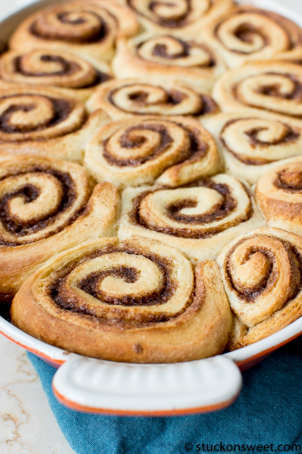 Fluffy cinnamon rolls with sweet glaze in a baking dish, perfect for breakfast or dessert. Freshly baked cinnamon rolls with swirls of cinnamon and sugar.