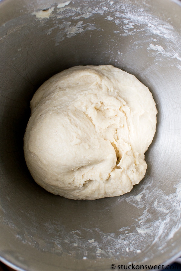 Flour dough ball in a metal mixing bowl for baking or dessert recipes.