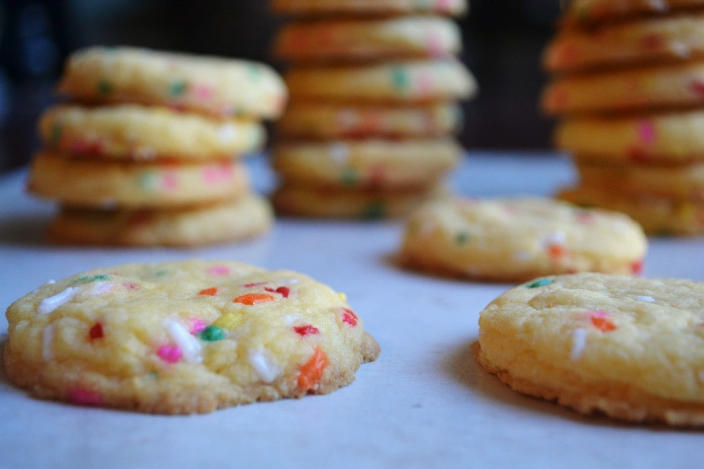 Colorful sprinkle sugar cookies with vibrant sprinkles, fresh out of the oven, perfect for sweet treats and dessert recipes. Ideal for holidays, celebrations, and cookie lovers.