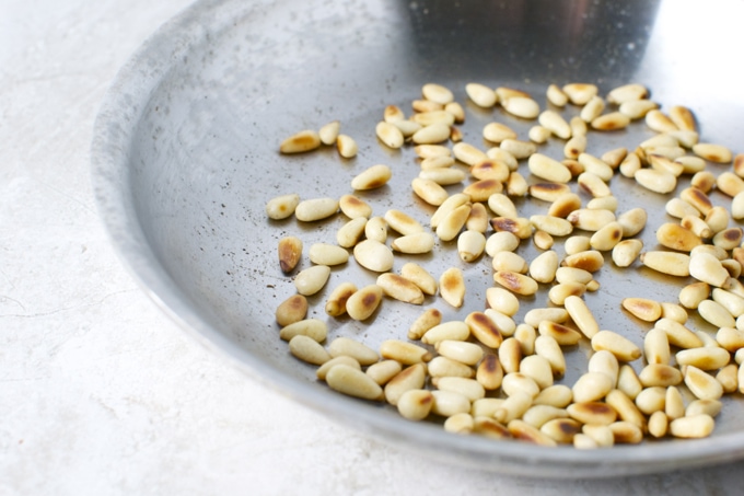 Roasted pine nuts on a baking sheet for baking or cooking recipes.