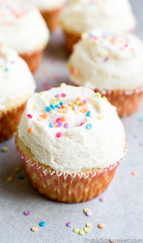 Bright Vanilla Cupcake with Colorful Rainbow Sprinkles and Creamy Frosting, Perfect for Celebrations.