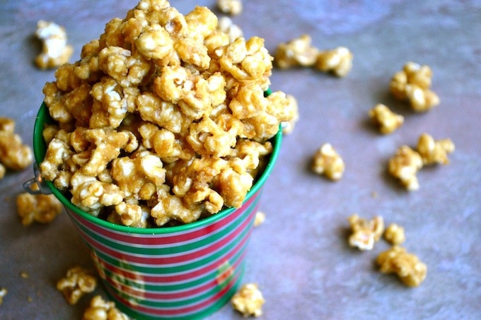 Buttered caramel popcorn in a festive striped cup, perfect for movie nights or sweet snacking. Made with crunchy popcorn coated in rich caramel flavor for a delicious treat.