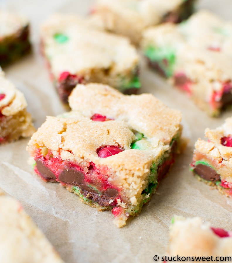Butterscotch chip cookie bars with red and green holiday candies, close-up view, baked sweet treats, Christmas dessert, festive cookie squares.