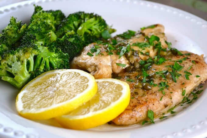Juicy grilled chicken with lemon slices and fresh broccoli, healthy dinner option, flavorful and nutritious meal, perfect for weight loss and balanced diet.