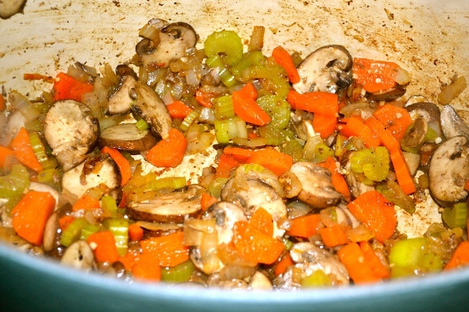 Sauteed mushrooms, carrots, and celery in a skillet, seasoned for a savory vegetable side dish. Perfect for healthy meals and enhanced flavors.