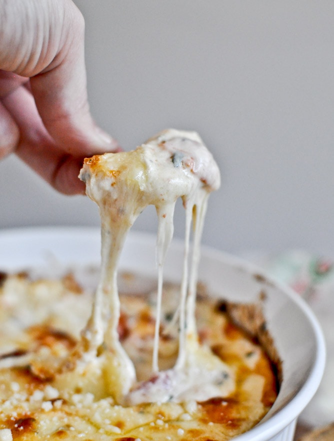 Creamy, cheesy pizza with gooey melted cheese stretching when lifted from a freshly baked dish.