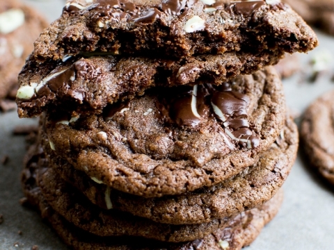 Buttery chocolate chip cookies with white chocolate chunks stacked, topped with a cookie, close-up, delicious baked treats, homemade cookies, sweet snack, dessert recipe, Stuck On Sweet.