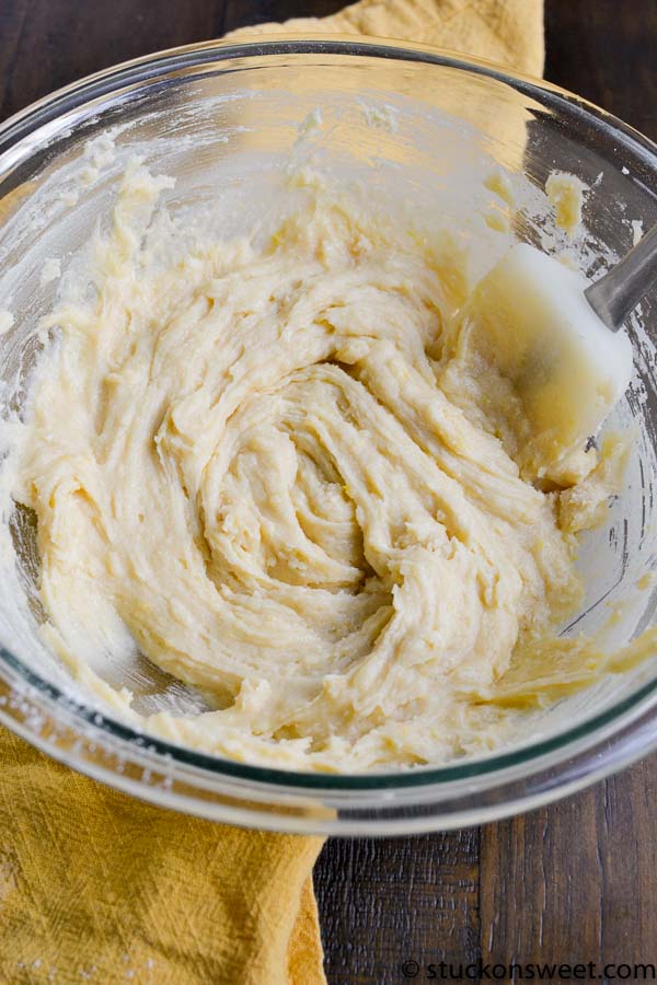 Smooth vanilla cookie dough in glass mixing bowl for baking recipes.