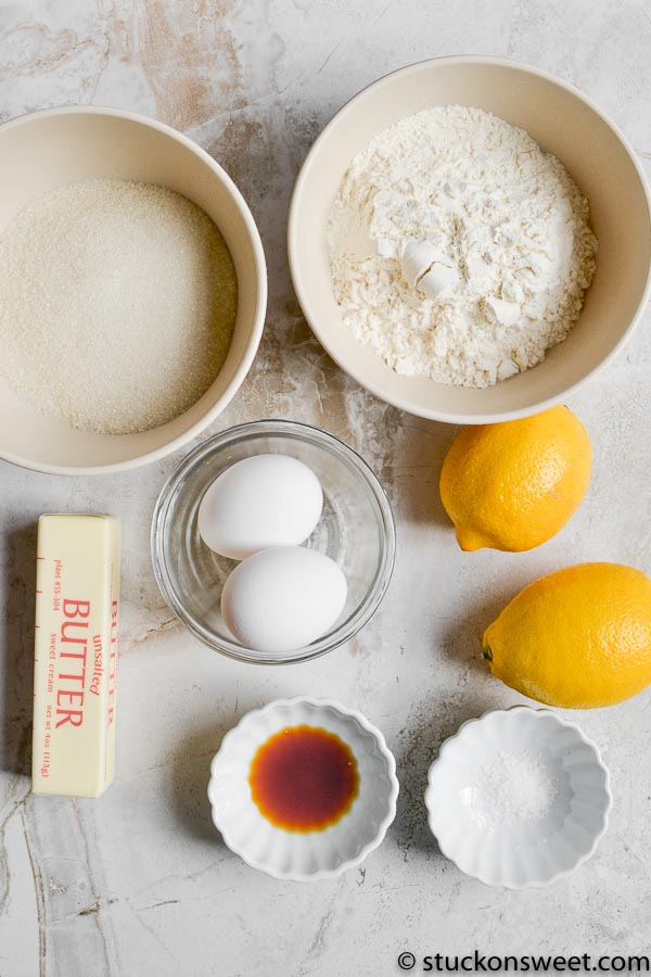 Softened butter, flour, sugar, eggs, lemon, vanilla extract, baking powder, and salt for lemon cake baking ingredients.