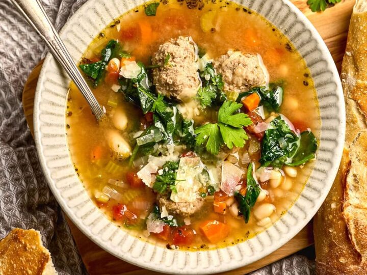 Comforting homemade turkey meatball soup with vegetables and spinach in a rustic setting. Perfect for cozy dinners and winter meals. Easy-to-make, hearty, and flavorful soup recipe.