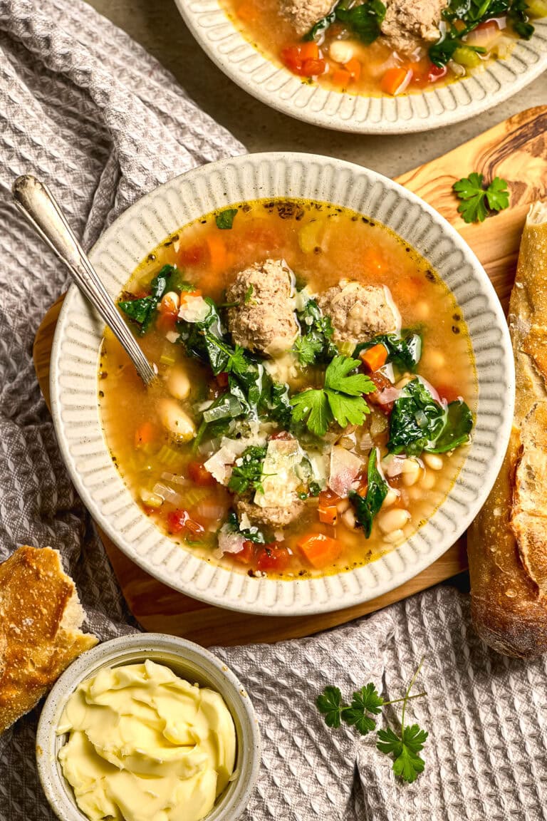 Comforting homemade turkey meatball soup with vegetables and spinach in a rustic setting. Perfect for cozy dinners and winter meals. Easy-to-make, hearty, and flavorful soup recipe.