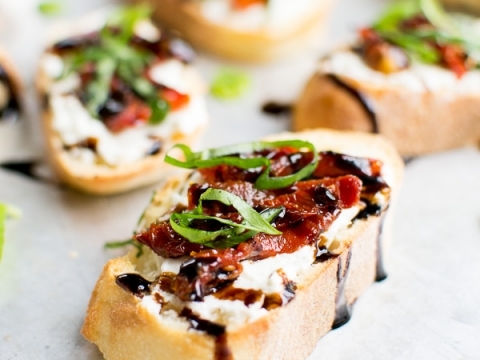 Crispy baguette slices topped with tomato, mozzarella, basil, and balsamic glaze, perfect appetizer or snack.