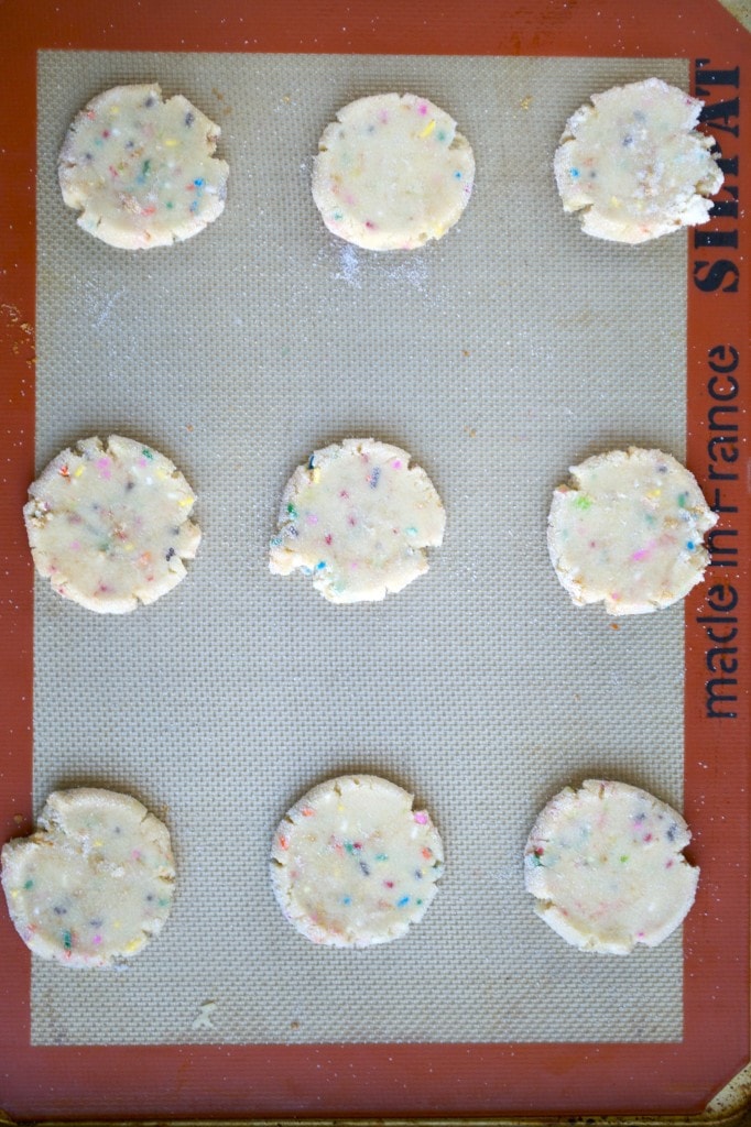 Colorful sprinkled cookie dough on a baking sheet for fun, festive treats.