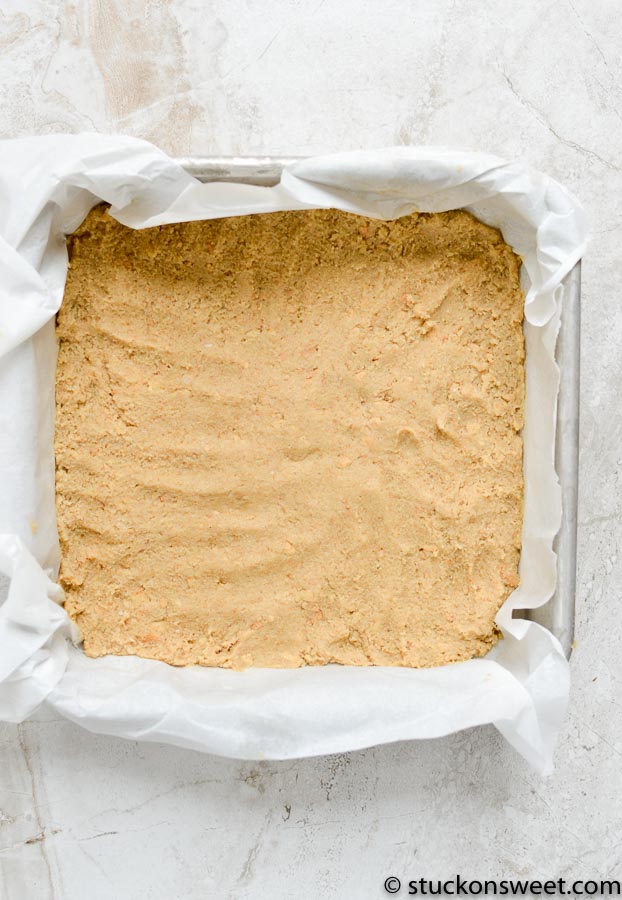 Golden brown cookie dough ready for baking in a parchment-lined baking pan. Perfectly smooth with a slightly textured surface, ready for cookies or dessert recipes.