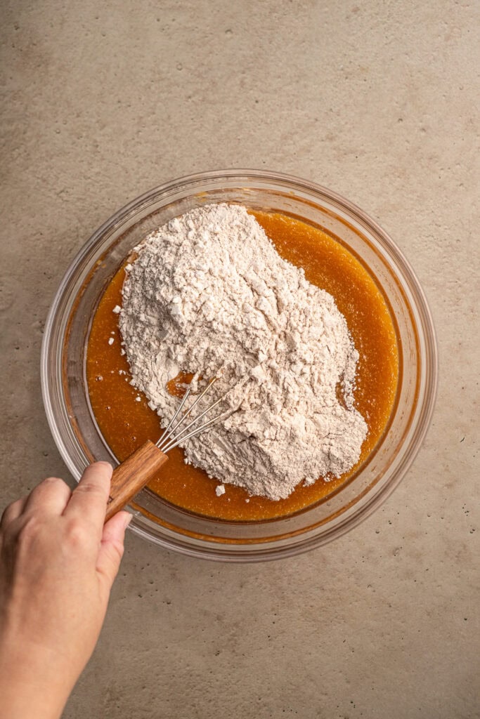 Cream being mixed into pumpkin puree for baking or dessert recipes.