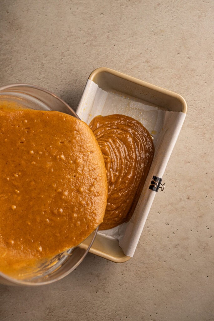 Creamy caramel sauce being poured into a baking dish, perfect for caramel desserts and sweet recipes.