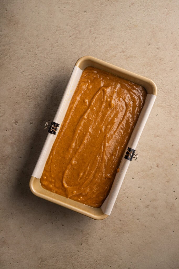 Creamy caramel fudge in a rectangular container, topped with a smooth caramel layer, perfect for sweet dessert lovers.