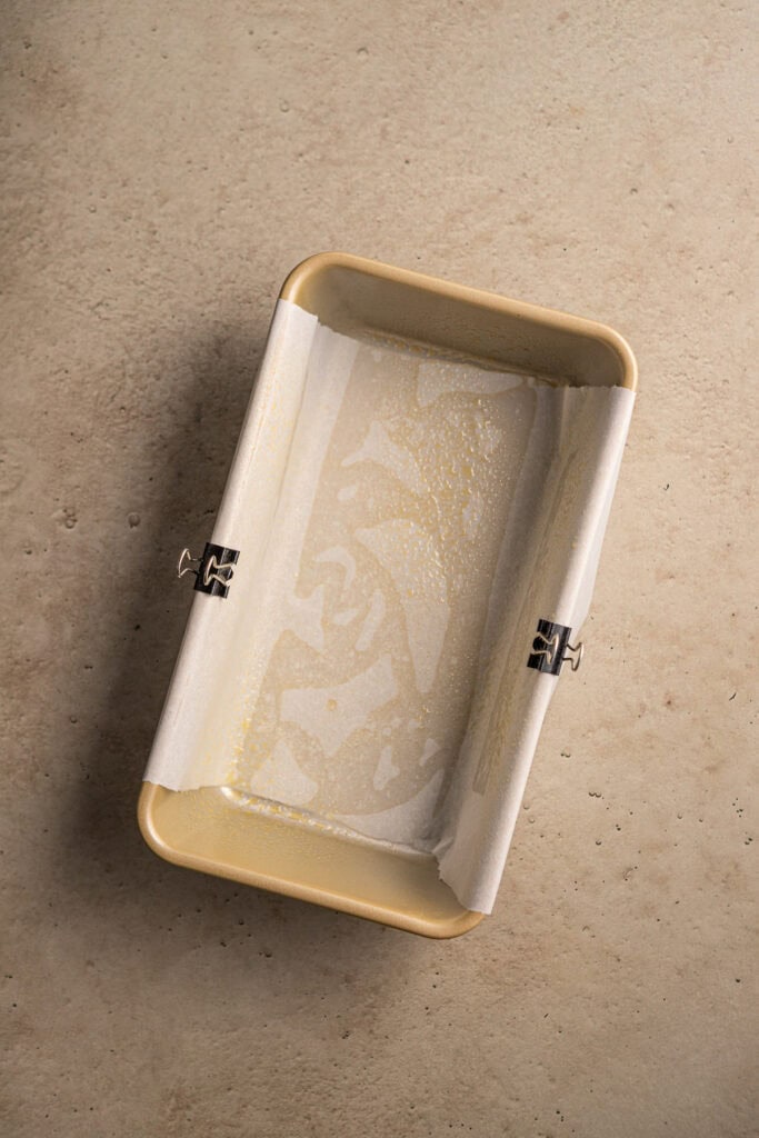 Silicone baking mold with remaining melted butter or oil, used for baking or preparing sweet treats and desserts.