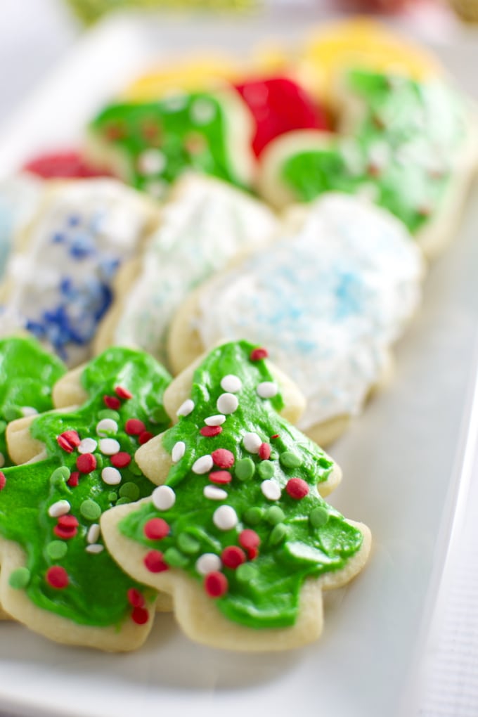 Colorful Christmas sugar cookies decorated with green, red, and white icing, topped with festive sprinkles, perfect for holiday baking and celebrations.