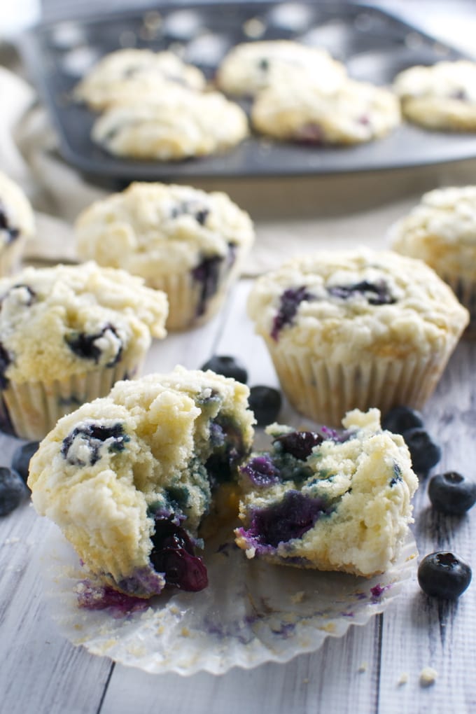 Freshly baked blueberry muffins with crumbly topping from Stuck On Sweet, perfect for a sweet snack or breakfast treat. Loaded with juicy blueberries, these muffins are moist and flavorful.