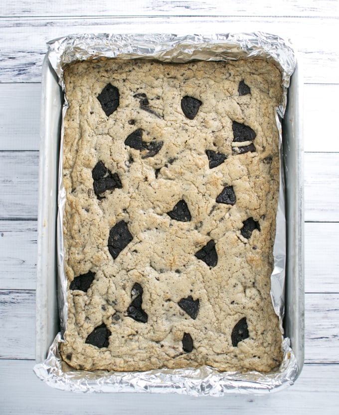 Chicago-style chocolate chip cookie bars with a crispy, golden brown crust and melty chocolate chunks cooling in a baking pan. Perfect for sweet snack cravings and dessert lovers.