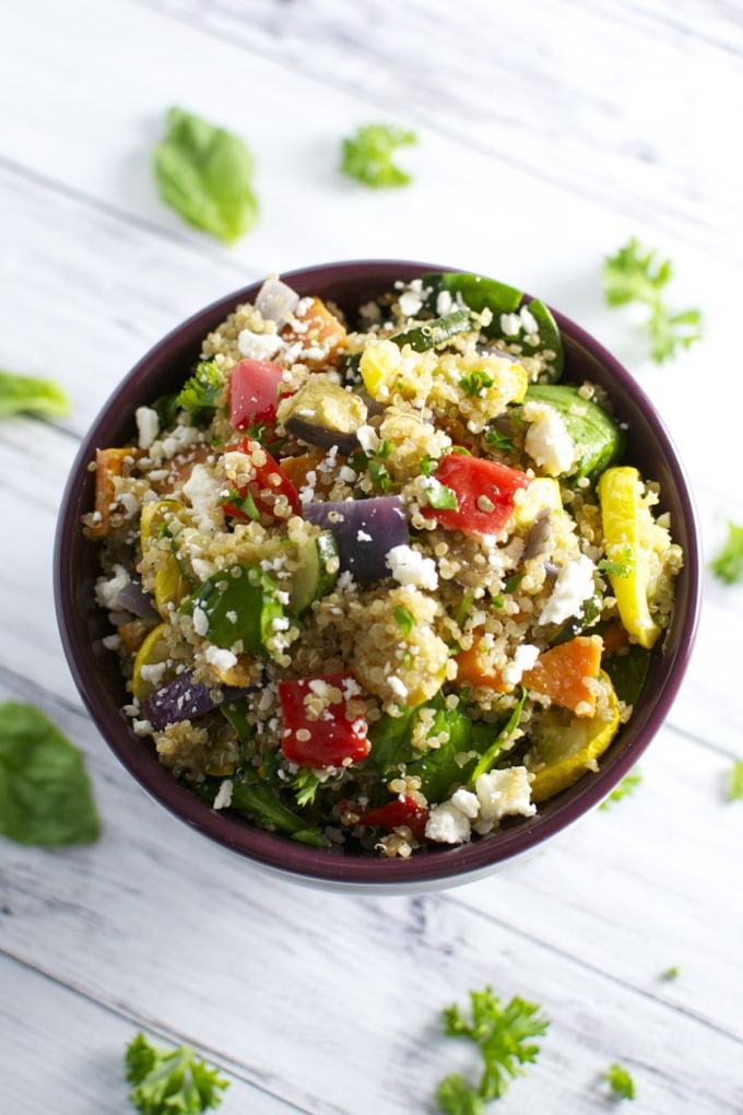 Colorful vegetable quinoa salad with feta cheese in a bowl, healthy vegan dinner or side dish, fresh ingredient image.