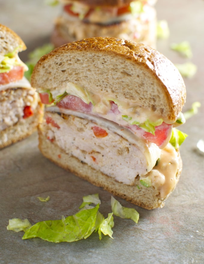 Freshly made chicken salad sandwich with lettuce and tomato on a soft sandwich bun, perfect for a delicious lunch.