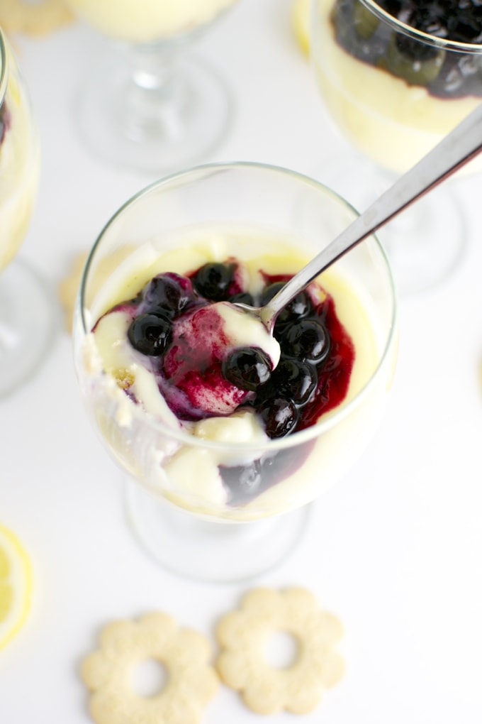 Delicious blueberry panna cotta dessert served in a glass with fresh berries and creamy custard. Perfect for summer gatherings and sweet tooth cravings at Stuck On Sweet.