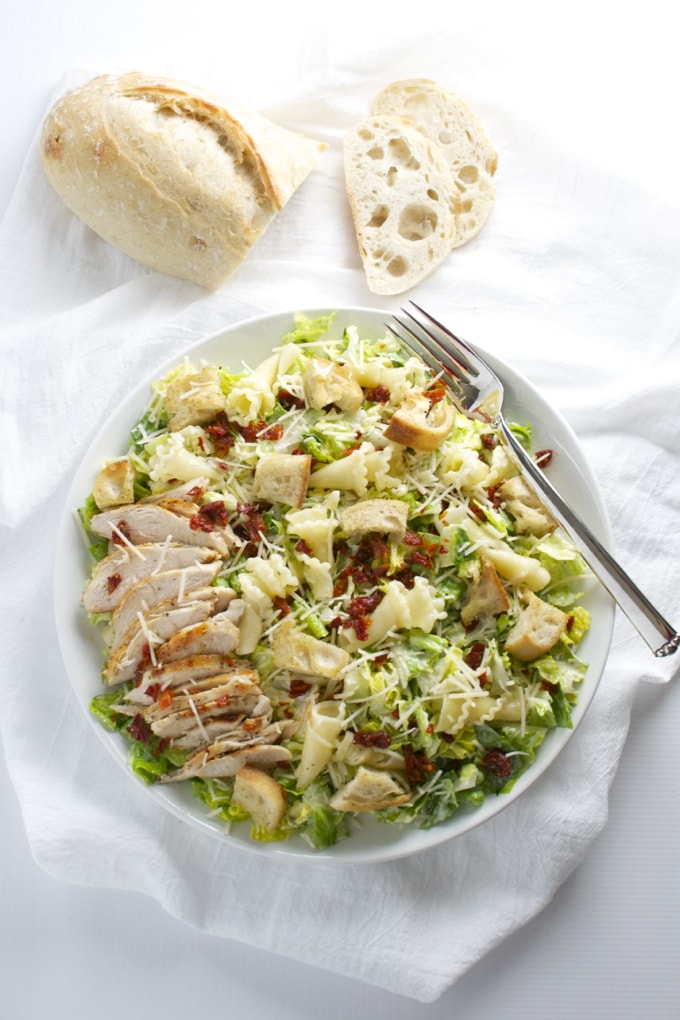 Parmesan Peppercorn Chicken Salad. This salad is packed full of delicous ingredients like sun dried tomatoes, romano cheese, homemade croutons and pasta! | stuckonsweet.com