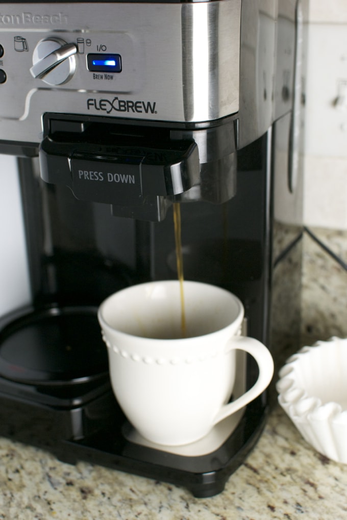 Freshly brewed coffee pouring into a white mug from a FlexBrew coffee maker, perfect for morning energy.