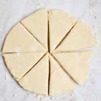 Buttery pie dough ready to be baked for sweet or savory pies, on a floured surface.