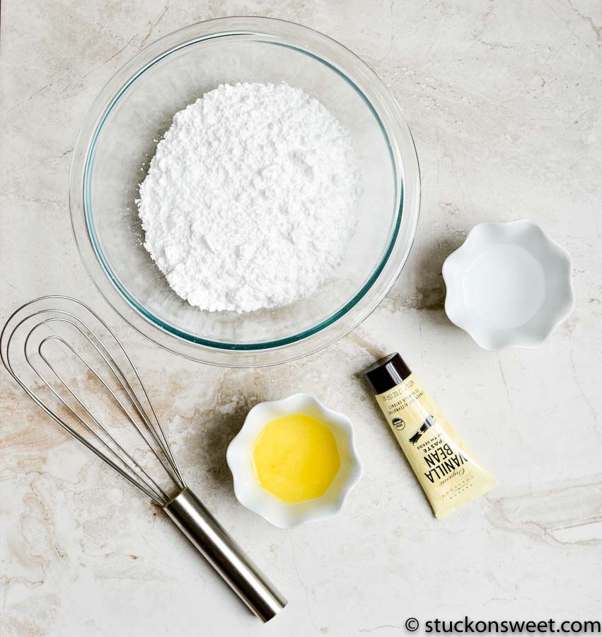 Powdered sugar, butter, and vanilla extract for homemade icing or frosting ingredients.