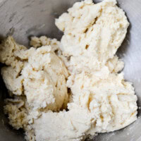 Butter mixture for cookie dough in a metal mixing bowl, ready for baking, close-up.