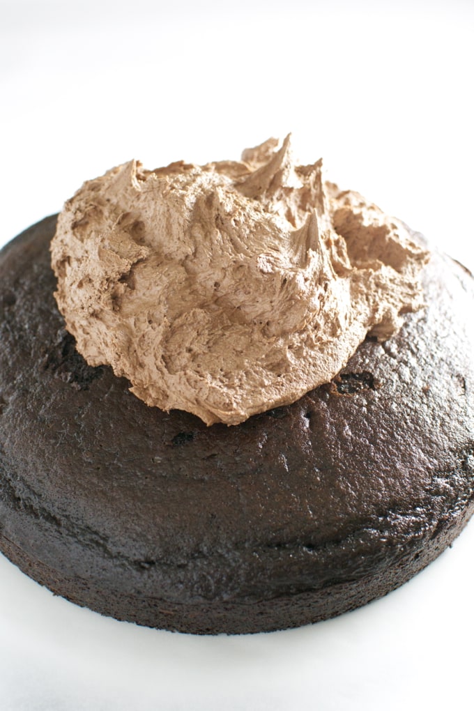 Decadent chocolate lava cake topped with rich chocolate mousse, perfect for dessert lovers and special occasions. Indulge in this sweet, gooey treat from Stuck On Sweet.