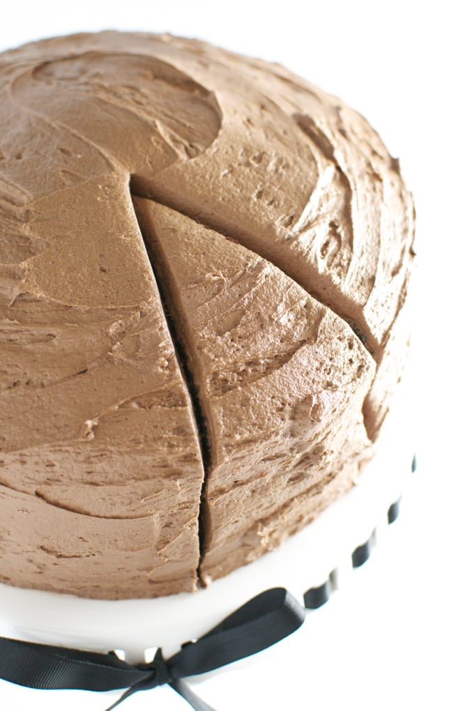 Rich chocolate frosting cake with smooth texture and decorative slices, perfect for special occasions and celebrations. A delectable dessert that delights chocolate lovers.