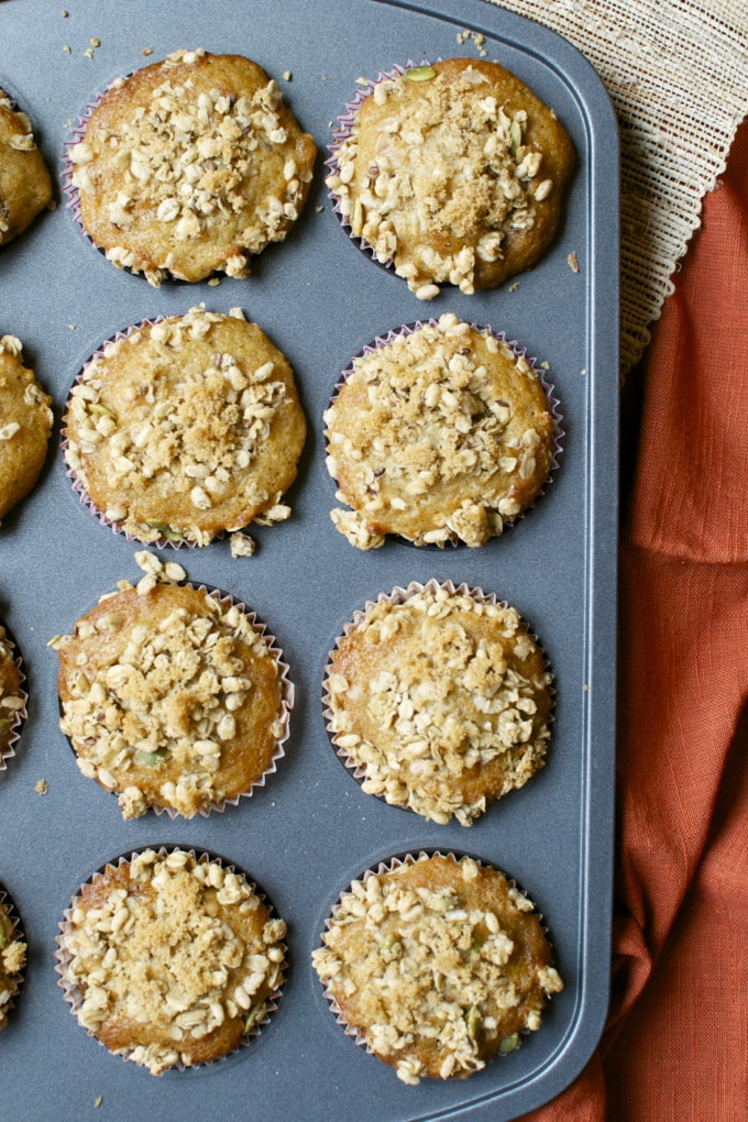 Delicious crumb-topped muffins in a muffin tin, perfect for breakfast or snacking. Freshly baked and topped with a crunchy crumb mixture, ideal for sweet breakfast treats or dessert.