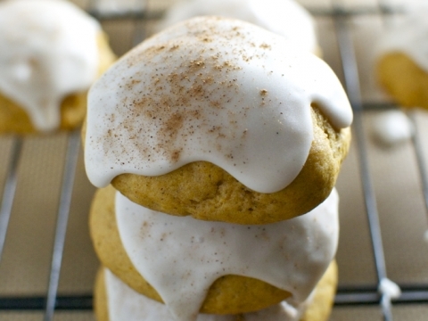 Buttermilk cookies with white icing and cinnamon topping on a wire rack.