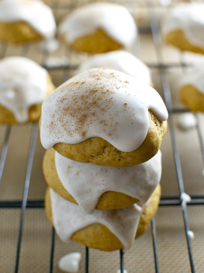 Buttermilk cookies with white icing and cinnamon topping on a wire rack.