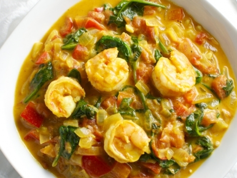 Creamy shrimp curry served in a white bowl, featuring vibrant seasonings, herbs, and tender seafood. Perfect for a flavorful weeknight dinner or special occasion.