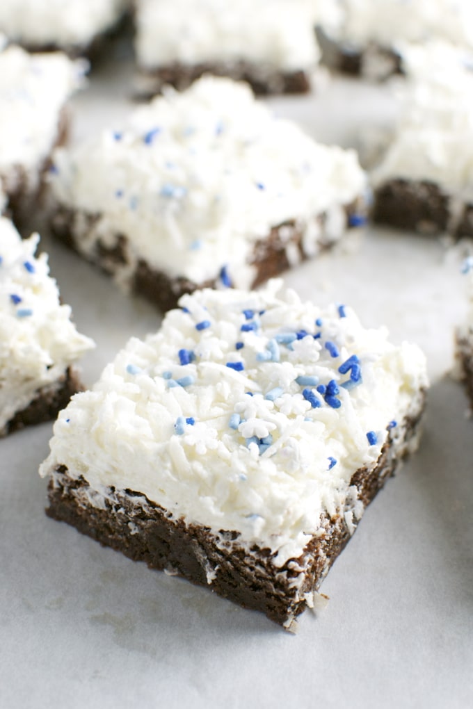 Sweet treat with rich chocolate base topped with creamy frosting and blue sprinkles, perfect for dessert lovers and celebration occasions.