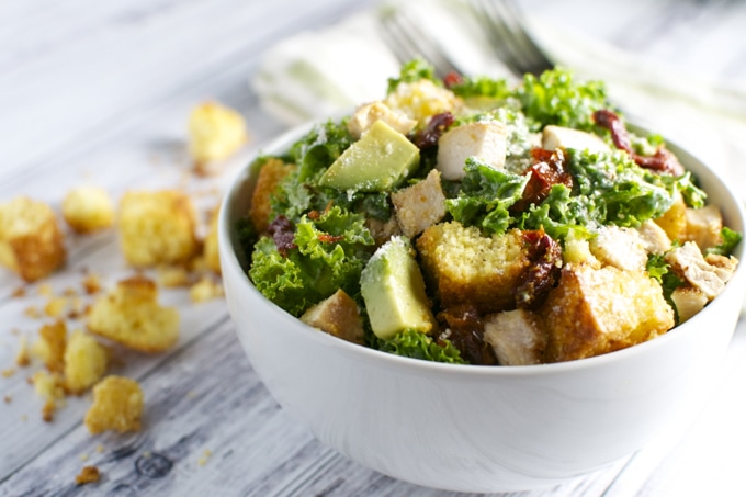 Kale Caesar Salad with Chicken, Sun Dried Tomatoes, Avocado, and Cornbread Croutons | stuckonsweet.com