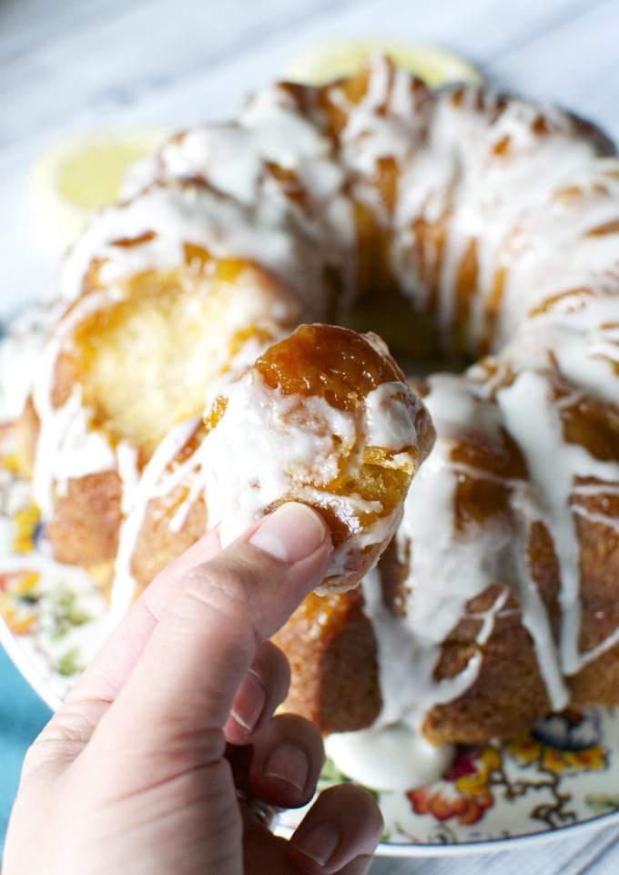 Soft lemon cake with icing and caramel glaze, served on a decorative plate perfect for celebrating spring gatherings.