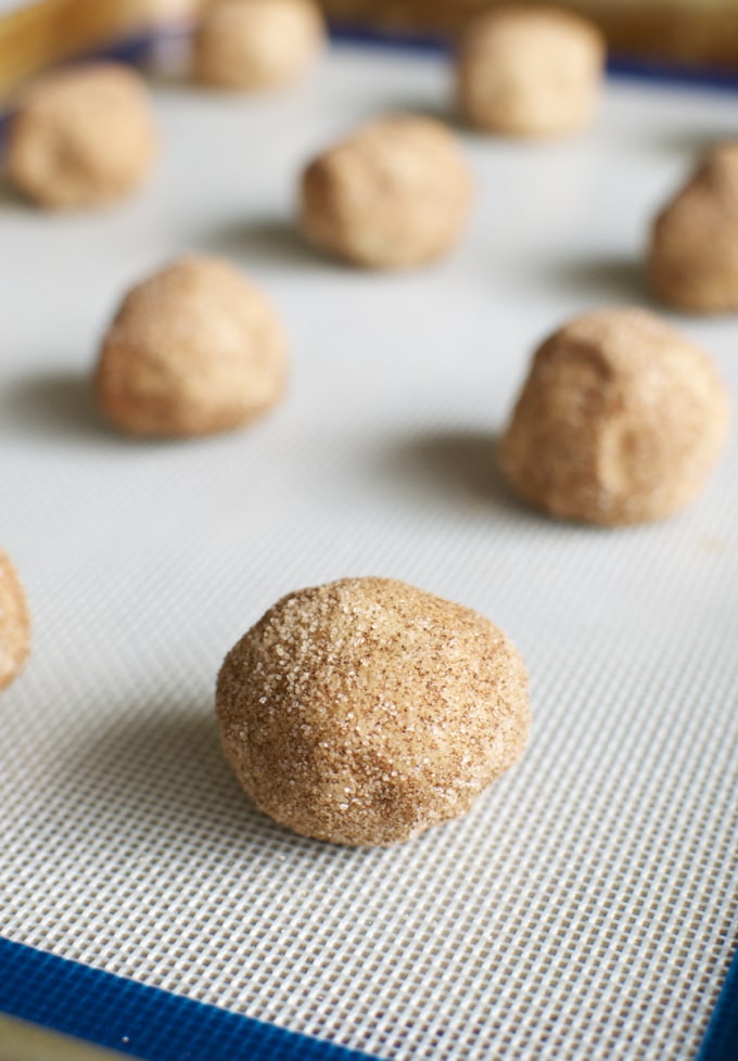 Snickerdoodle cookie dough balls on baking sheet, ready for baking, delicious sweet treat, no bake dessert, dessert recipes, bakery, confectionery, Stuck On Sweet, cookies, homemade cookies.
