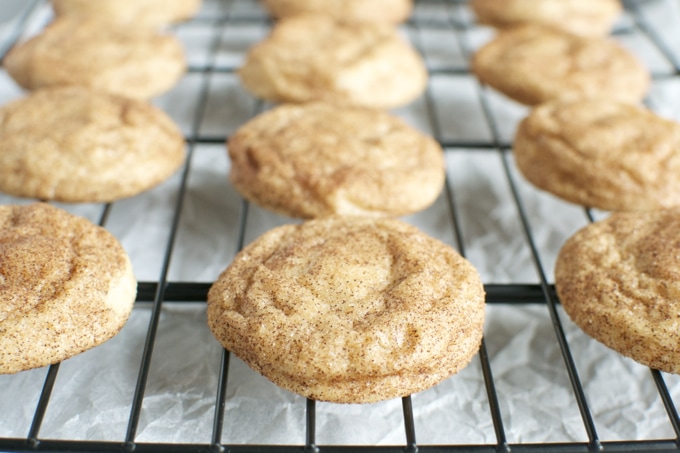 Freshly baked snickerdoodle cookies cooling on a wire rack, perfect for sharing or gifting, showcasing delicious homemade baked goods from Stuck On Sweet.