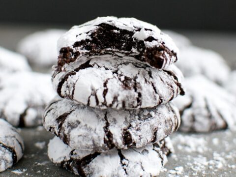 Chocolate Crinkle Cookies stacked on top of each other