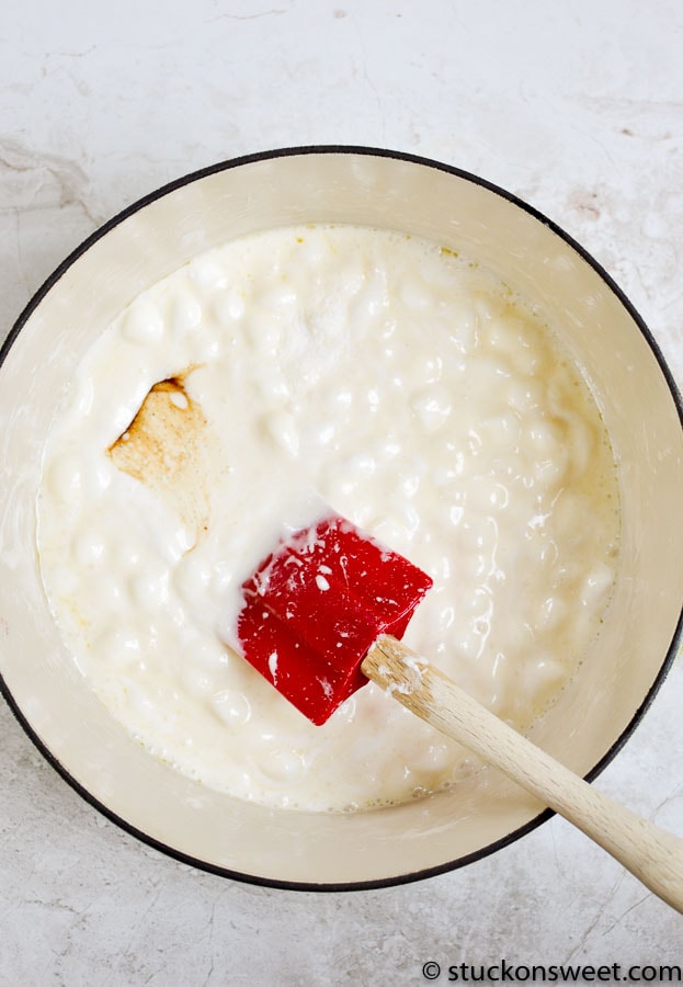 Cream cheese and butter melting in a saucepan for a sweet dessert recipe.