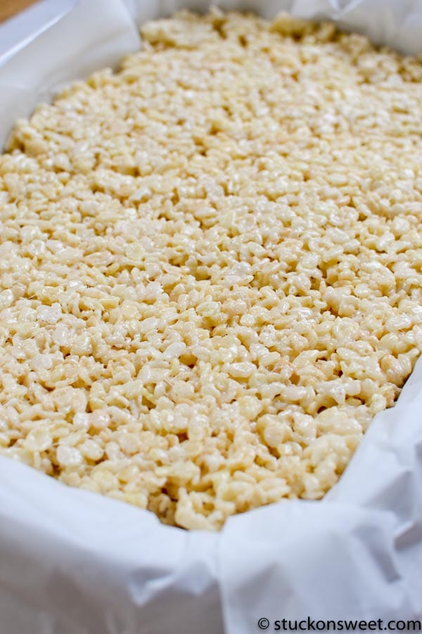 gooey rice krispie treats on parchment paper.