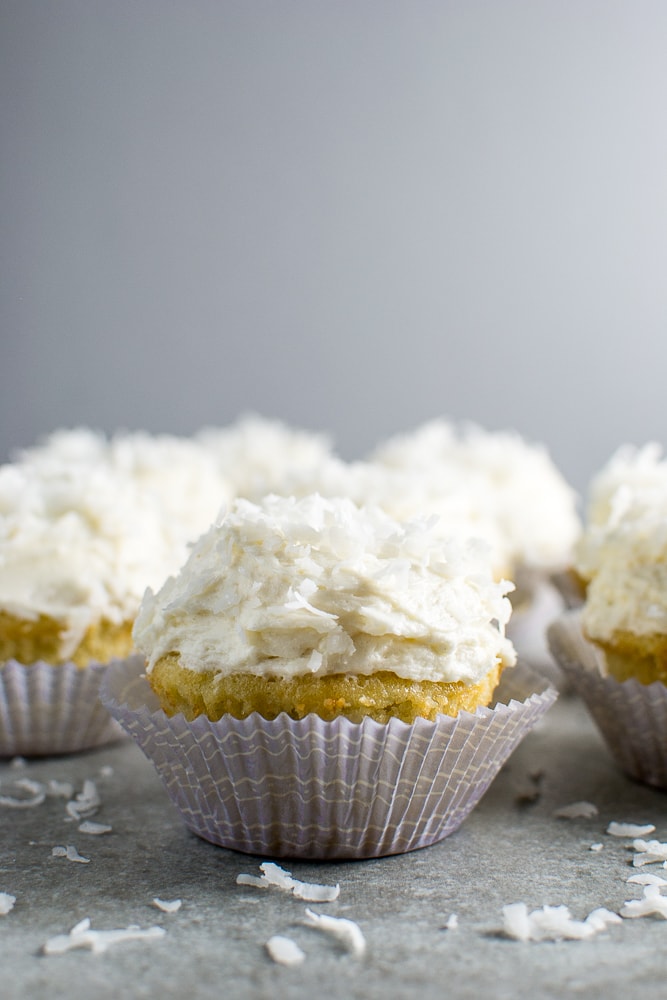 Cream cheese frosting cupcakes, vanilla cupcake with creamy topping, delicious sweet treat, bakery style cupcakes, Stuck On Sweet dessert, white chocolate shavings, indulgent comfort food, dessert recipe, homemade cupcakes, bakery quality cupcakes, perfect for celebrations, moist and fluffy cupcake, frosting decorated cupcake, wedding or birthday cupcakes, handcrafted bakery desserts, decadent sweet dessert, dessert photography, dessert inspiration, Stuck On Sweet bakery, elegant dessert presentation.